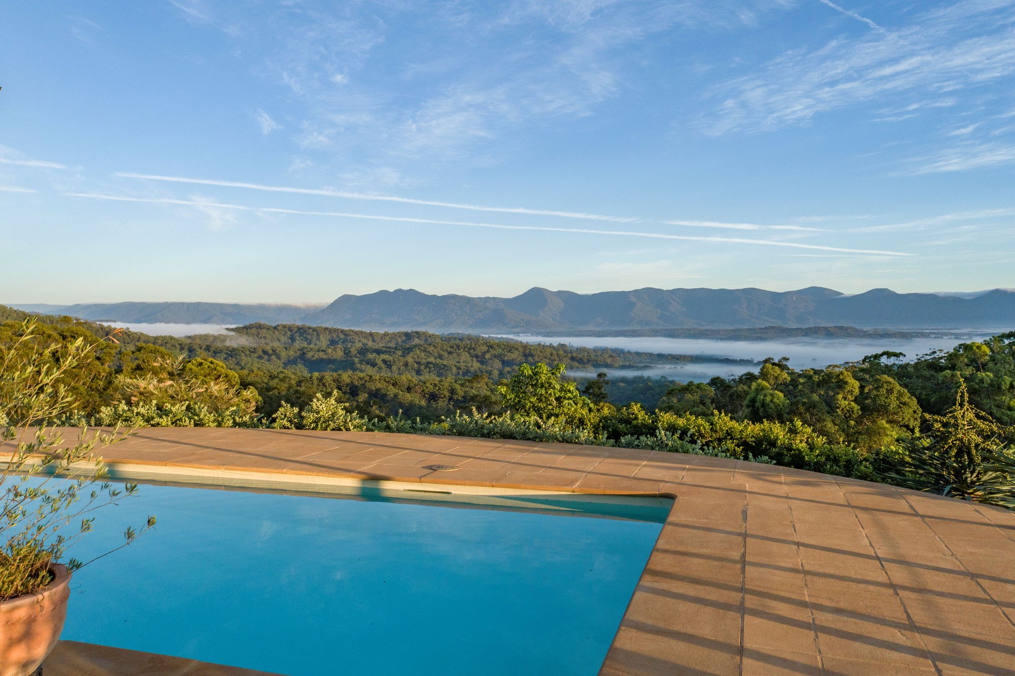 Pool deck at Hilltop Sanctuary looking over the valley at golden hour